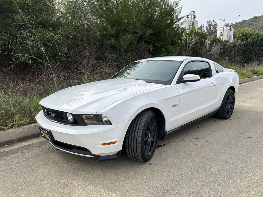 Freshly detailed 2012 white Ford Mustang GT with black wheels