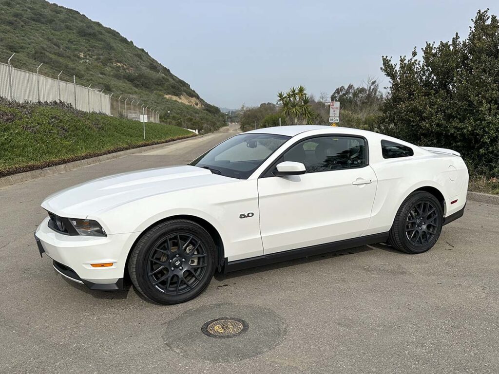 Freshly detailed 2012 white Ford Mustang GT with black wheels